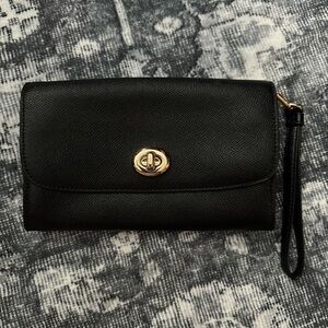 Black leather Coach clutch. Gold hardware.